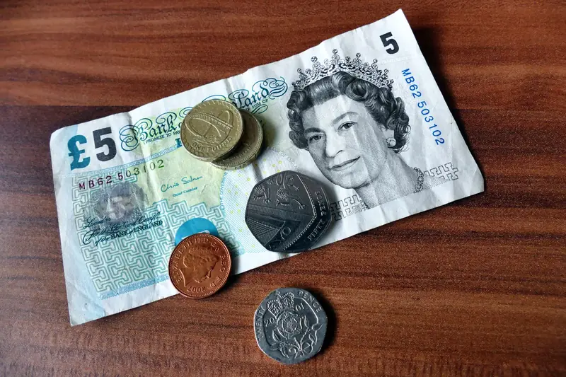 British pound notes and coins representing the cost of dry ridge and dry verge work in Croydon