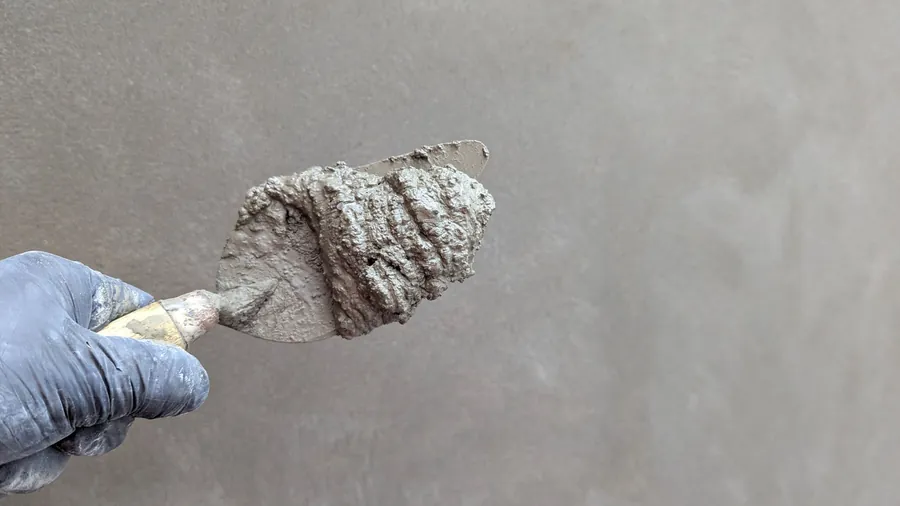 Fresh sand and cement mortar on a trowel, the traditional bedding for ridge and verge tiles