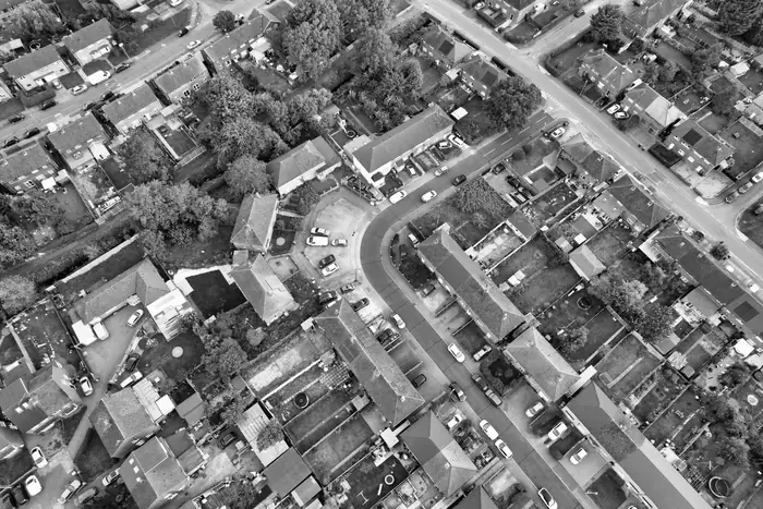 Aerial view of a residential area showing rear extensions, flat roofs and back gardens behind rows of houses