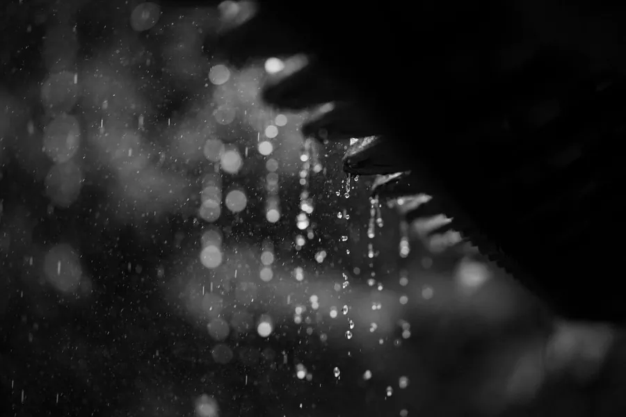 Heavy rain running off the edge of a roof during a storm