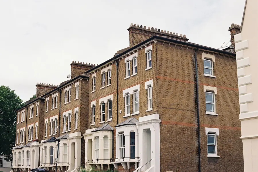 Tall Victorian houses in London stock brick with bay windows, the type often divided into flats