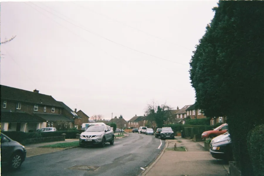 A street of interwar semi-detached houses in Croydon under a grey sky