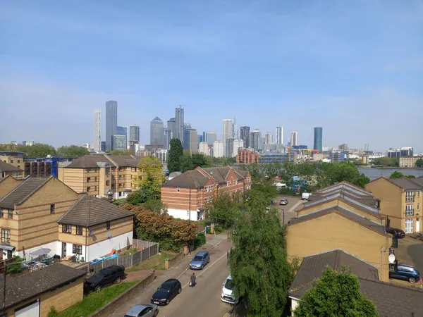View across south London rooftops towards the towers of Canary Wharf