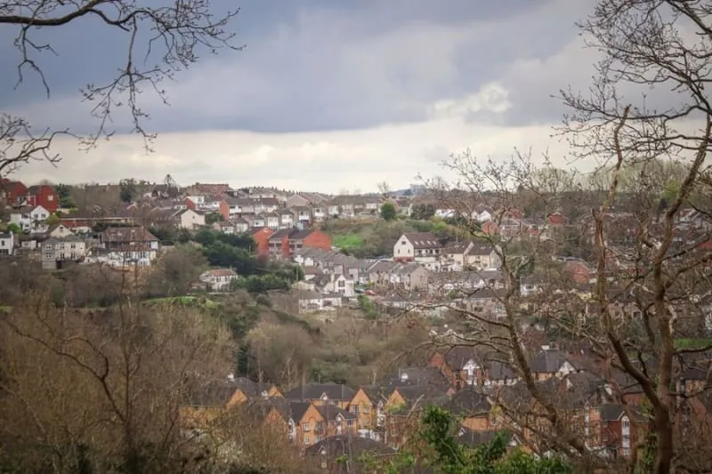 Pitched roofs of detached houses stepping up a wooded hillside on the southern edge of Croydon